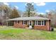 Attractive brick home with a covered carport and manicured landscaping at 3402 Pat Tilley Rd, Bahama, NC 27503