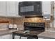 A kitchen featuring black appliances, tiled backsplash and contrasting countertops at 3402 Pat Tilley Rd, Bahama, NC 27503