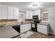 Galley kitchen featuring white cabinets and stainless steel appliances at 3402 Pat Tilley Rd, Bahama, NC 27503