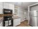 Kitchen area with stainless steel appliances and tile backsplash at 3402 Pat Tilley Rd, Bahama, NC 27503