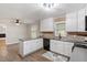 Open kitchen featuring white cabinets and dark countertops at 3402 Pat Tilley Rd, Bahama, NC 27503
