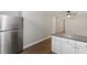 Kitchen area with stainless steel refrigerator and laminate floors at 3402 Pat Tilley Rd, Bahama, NC 27503
