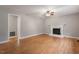 Spacious living room with hardwood floors, ceiling fan, and a fireplace at 3402 Pat Tilley Rd, Bahama, NC 27503