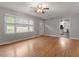 Bright living room with large windows, hardwood floors, and white trim at 3402 Pat Tilley Rd, Bahama, NC 27503