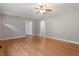 Open living room with hardwood floors, ceiling fan, and neutral paint at 3402 Pat Tilley Rd, Bahama, NC 27503