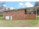 Back of a single-story brick home with attached garage and covered porch at 3402 Pat Tilley Rd, Bahama, NC 27503