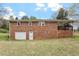 Spacious backyard featuring a single-story brick home with attached garage at 3402 Pat Tilley Rd, Bahama, NC 27503