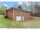 Back of a single-story brick home with attached garage and covered porch at 3402 Pat Tilley Rd, Bahama, NC 27503