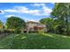 Expansive backyard featuring lush lawn and a covered porch, perfect for outdoor entertaining and relaxation at 3824 Laurel Hills Rd, Raleigh, NC 27612
