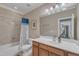 Well-lit bathroom boasts a vanity, framed mirror, tiled shower, and tub combination with modern fixtures at 3824 Laurel Hills Rd, Raleigh, NC 27612