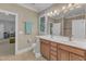 Modern bathroom with double vanity, tile flooring, and a large mirror offering ample natural light at 3824 Laurel Hills Rd, Raleigh, NC 27612