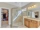 Bathroom with a walk-in shower, vanity with granite countertop, and a view into a closet at 3824 Laurel Hills Rd, Raleigh, NC 27612