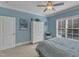 Bedroom with blue walls, crown molding, and a seating area by a window providing natural light at 3824 Laurel Hills Rd, Raleigh, NC 27612