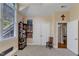 Bright bedroom features a large window, beige carpet, and storage shelves for athletic and collector's items at 3824 Laurel Hills Rd, Raleigh, NC 27612