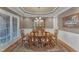 Formal dining room featuring a large wooden table, upholstered chairs, and a decorative chandelier at 3824 Laurel Hills Rd, Raleigh, NC 27612