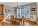 Dining room features an elegant chandelier, wainscoting, hardwood floors and bright windows at 3824 Laurel Hills Rd, Raleigh, NC 27612