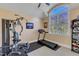 Home gym with exercise equipment and a large window providing natural light and ventilation at 3824 Laurel Hills Rd, Raleigh, NC 27612