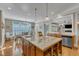 Bright kitchen island with granite countertop overlooking the breakfast area and living room at 3824 Laurel Hills Rd, Raleigh, NC 27612