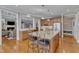Spacious kitchen features granite countertops, stainless steel appliances, island with bar seating and light hardwood floors at 3824 Laurel Hills Rd, Raleigh, NC 27612