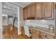 Kitchen features granite countertops, stainless steel appliances, built-in desk and light hardwood floors at 3824 Laurel Hills Rd, Raleigh, NC 27612