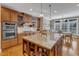 Spacious kitchen features granite countertops, stainless steel appliances, an island and light hardwood floors at 3824 Laurel Hills Rd, Raleigh, NC 27612