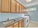 Functional laundry room featuring granite countertops, ample cabinet storage, and modern washer and dryer at 3824 Laurel Hills Rd, Raleigh, NC 27612