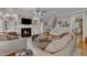 Inviting living space with fireplace, TV, plush seating, and access to staircase at 3824 Laurel Hills Rd, Raleigh, NC 27612