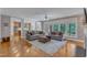 Spacious living room with hardwood floors, natural light, and seamless flow to kitchen at 3824 Laurel Hills Rd, Raleigh, NC 27612