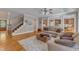 Open concept living room showcasing hardwood floors, staircase, and view to kitchen at 3824 Laurel Hills Rd, Raleigh, NC 27612
