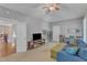 Spacious living room features a cozy blue sofa, flat screen tv, and plush carpet with lots of natural light at 3824 Laurel Hills Rd, Raleigh, NC 27612