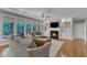 Comfortable living area featuring a fireplace, large windows, and cozy seating at 3824 Laurel Hills Rd, Raleigh, NC 27612