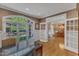Office space featuring hardwood floors, a large arched window, and an open doorway to dining room at 3824 Laurel Hills Rd, Raleigh, NC 27612