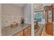 The Butler's pantry features granite countertops, built-in cabinetry and light hardwood floors at 3824 Laurel Hills Rd, Raleigh, NC 27612