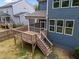 A wooden deck and screened porch look out over the backyard of a blue home at 3866 Keohane Dr, Durham, NC 27705