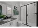 Modern bathroom showcases a sleek glass-enclosed shower, white marble tile and stone countertop at 3866 Keohane Dr, Durham, NC 27705