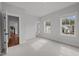 Bedroom featuring plush carpeting, a double-window, neutral walls, white trim and an ensuite bathroom at 3866 Keohane Dr, Durham, NC 27705