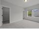 Bright bedroom featuring plush carpeting, a double-window, neutral walls, white trim and a walk-in closet at 3866 Keohane Dr, Durham, NC 27705