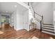Spacious foyer with hardwood floors and staircase; the entryway offers a bright and welcoming ambiance at 3866 Keohane Dr, Durham, NC 27705