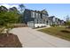 Exterior showcases a spacious driveway and beautiful front yard with well-manicured landscaping at 3866 Keohane Dr, Durham, NC 27705