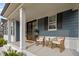 Cozy front porch with comfortable wicker seating, perfect for relaxing and enjoying the outdoors at 3866 Keohane Dr, Durham, NC 27705