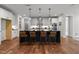 Kitchen island with black countertop and seating, with stainless steel appliances at 3866 Keohane Dr, Durham, NC 27705