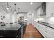 Modern kitchen with a black countertop island, pendant lights, and stainless steel appliances at 3866 Keohane Dr, Durham, NC 27705