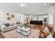 Open-concept living room with hardwood floors and seamless flow into the kitchen at 3866 Keohane Dr, Durham, NC 27705