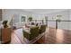 Upstairs living room with hardwood flooring, stylish seating, and natural light from the large windows at 3866 Keohane Dr, Durham, NC 27705