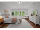 Sun-filled main bedroom features a tray ceiling, natural light, wood floors and neutral colors at 3866 Keohane Dr, Durham, NC 27705