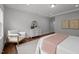 Light filled main bedroom with wood floors, tray ceiling, dresser, decor, and neutral wall colors at 3866 Keohane Dr, Durham, NC 27705
