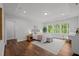 Main bedroom boasts a tray ceiling, wood floors and large windows with natural light at 3866 Keohane Dr, Durham, NC 27705