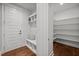 Mudroom with coat rack, shelves, storage bench, and a door that leads to a shelved pantry at 3866 Keohane Dr, Durham, NC 27705