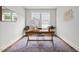 Bright office space showcasing a large window, wooden desk, and colorful area rug at 3866 Keohane Dr, Durham, NC 27705