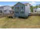 Rear exterior view shows a two-story home with a wood deck and well-maintained lawn at 3866 Keohane Dr, Durham, NC 27705